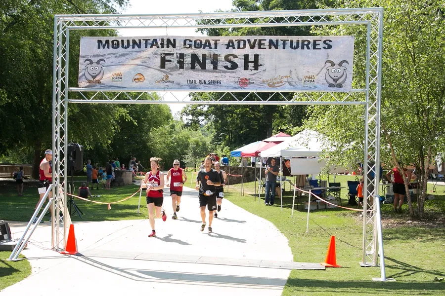 Runners approaching the Mountain Goat Adventures finish line